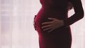 stress vrouw in rode jurk is zwanger